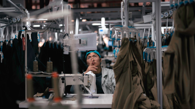 A woman works in the Hualida clothing factory in Changzhou, Jiangsu Province, China, 14 November 2023